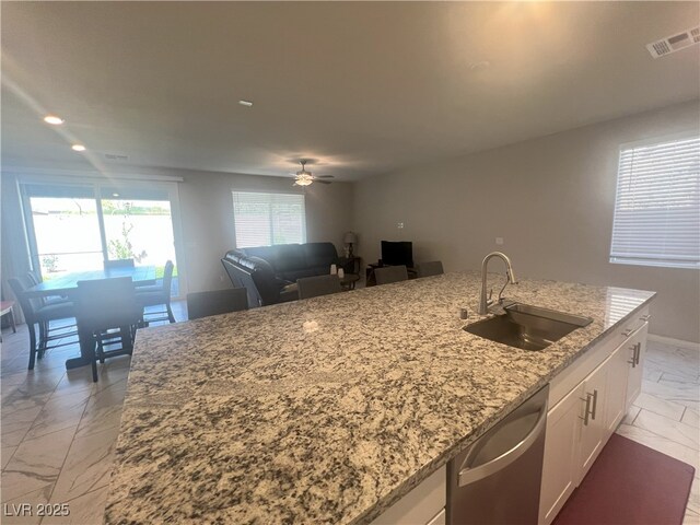 7527 Ardenno St, North Las Vegas, NV 89084 - kitchen with a sink, light marble finish floors, dishwasher, light stone counters, and white cabinetry