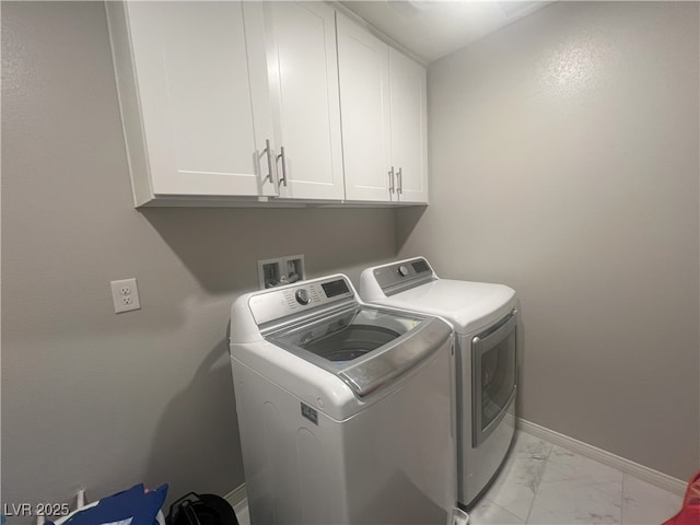 7527 Ardenno St, North Las Vegas, NV 89084 - clothes washing area featuring washing machine and clothes dryer, light marble finish flooring, cabinet space, and baseboards