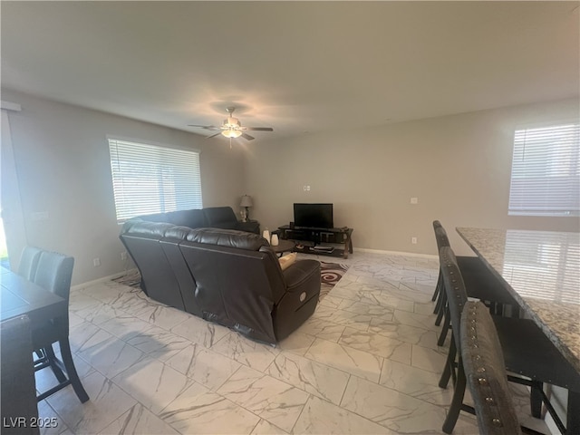 7527 Ardenno St, North Las Vegas, NV 89084 - living area featuring light marble finish flooring, ceiling fan, and baseboards