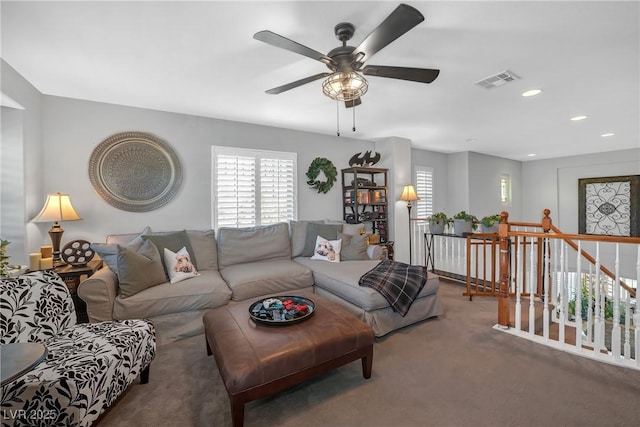 carpeted living area with recessed lighting, ceiling fan, visible vents, and a wealth of natural light