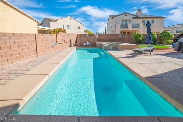 view of swimming pool with a fenced backyard, a patio area, and a pool with connected hot tub