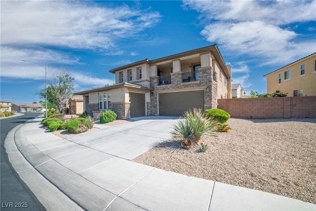 view of front facade with a garage, fence, stone siding, stucco siding, and concrete driveway