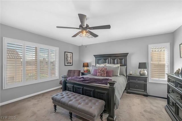 bedroom with light colored carpet, baseboards, and ceiling fan
