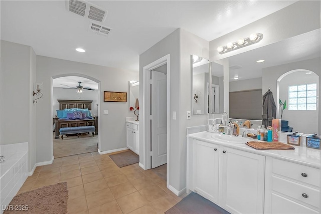 ensuite bathroom featuring visible vents, tile patterned flooring, vanity, ceiling fan, and ensuite bath