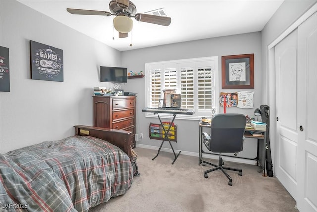 carpeted bedroom with a ceiling fan, baseboards, visible vents, and a closet