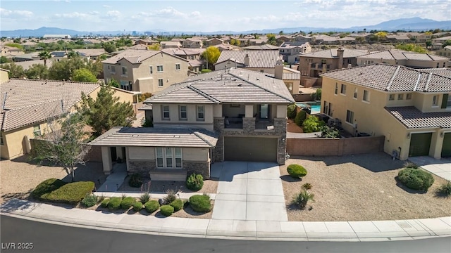 birds eye view of property featuring a mountain view and a residential view