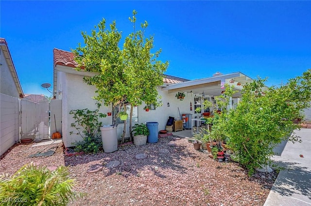 7874 Trail Boss Ct, Las Vegas, NV 89113 - view of side of home with a tiled roof, stucco siding, and a gate