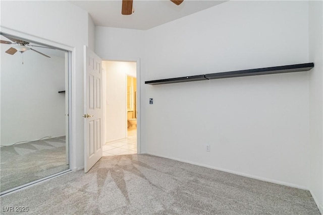 unfurnished bedroom featuring a closet, a ceiling fan, and carpet flooring