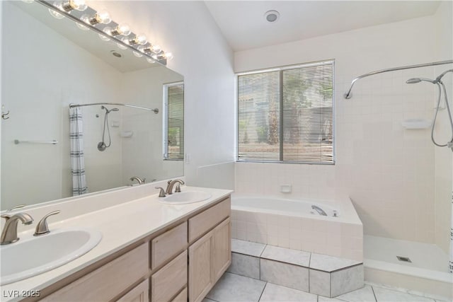 bathroom featuring a sink, tiled shower, and a healthy amount of sunlight