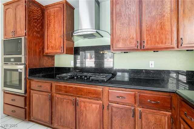 kitchen with dark countertops, wall chimney exhaust hood, black gas cooktop, and oven