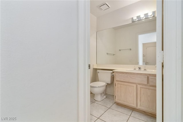 half bath with toilet, tile patterned floors, visible vents, and vanity