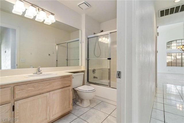 bathroom featuring visible vents, tile patterned flooring, vanity, toilet, and combined bath / shower with glass door