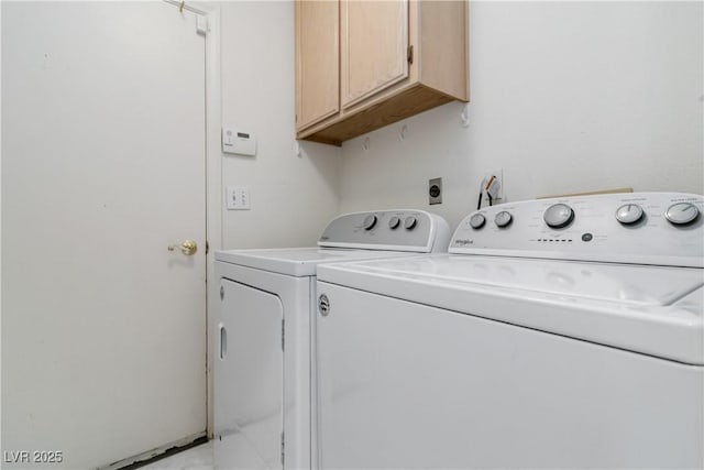 clothes washing area with cabinet space and independent washer and dryer