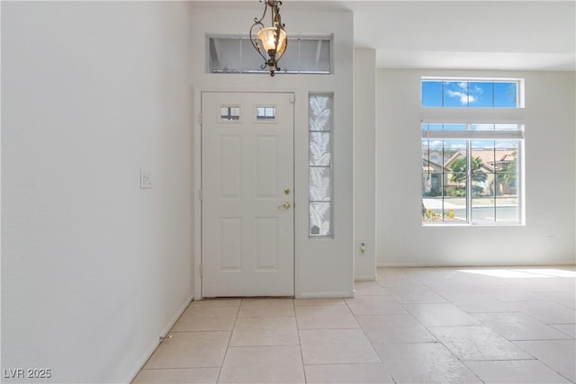 entryway featuring baseboards and light tile patterned floors