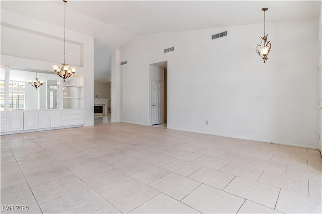 unfurnished room featuring visible vents, light tile patterned flooring, and a chandelier