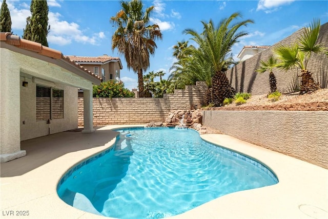 view of swimming pool with a patio, a fenced in pool, and a fenced backyard