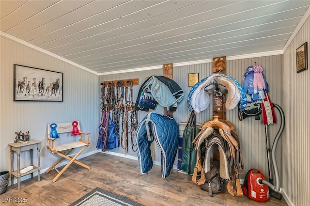 interior space with ornamental molding, wood ceiling, and wood finished floors