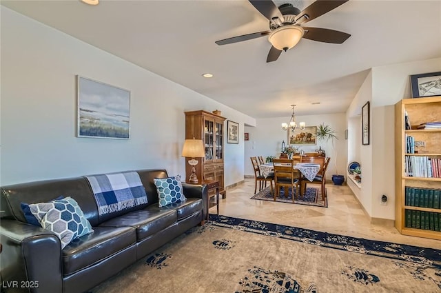 living area with recessed lighting, marble finish floor, and ceiling fan with notable chandelier