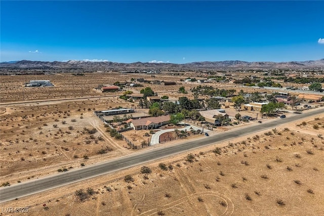 aerial view featuring view of desert, a mountain view, and a rural view