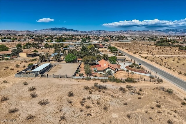drone / aerial view featuring a rural view, a mountain view, and a desert view