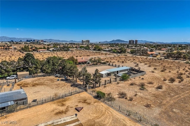 birds eye view of property featuring a desert view, a mountain view, and a rural view