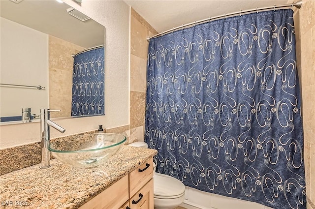 full bathroom with vanity and toilet