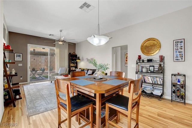 dining area with ceiling fan, visible vents, baseboards, and light wood-style floors