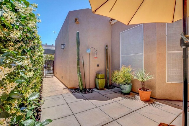 130 Twin Towers Ave, Las Vegas, NV 89123 - exterior space featuring a gate, a patio area, and stucco siding