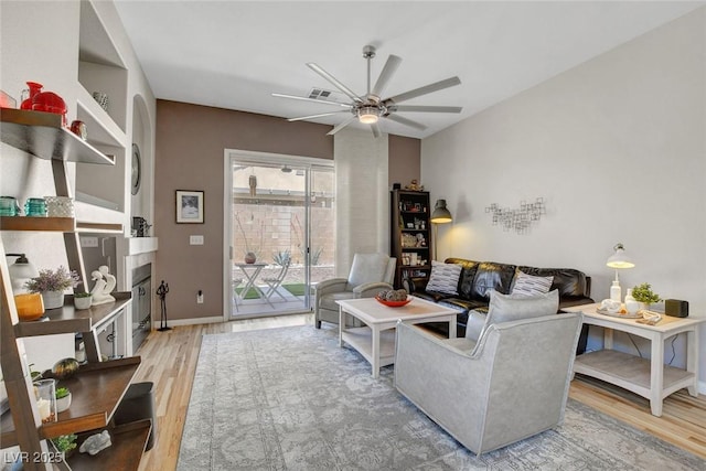 130 Twin Towers Ave, Las Vegas, NV 89123 - living area featuring light wood-style floors, visible vents, a glass covered fireplace, and ceiling fan
