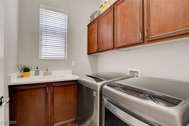 laundry room featuring a sink, cabinet space, and washing machine and dryer