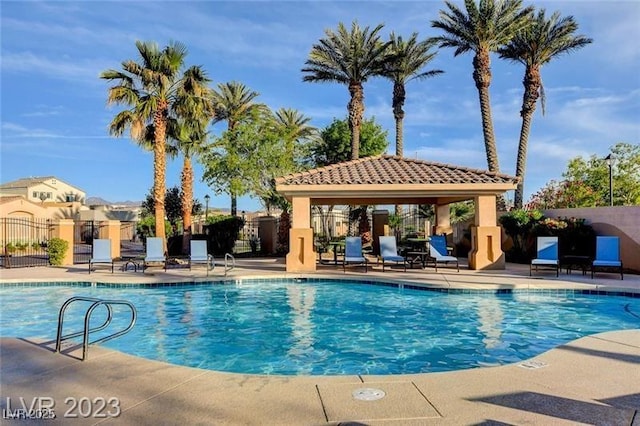 pool with a gazebo, a patio area, and fence