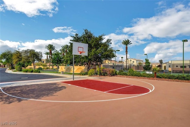 view of basketball court featuring fence and community basketball court