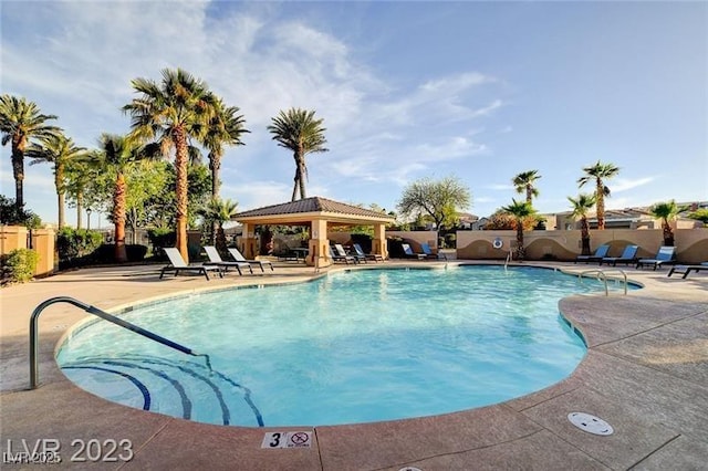pool featuring a gazebo, fence, and a patio