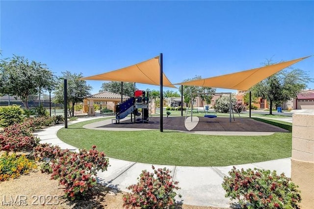 community jungle gym featuring a lawn