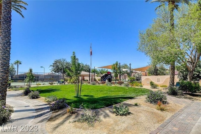 view of home's community featuring a yard and fence