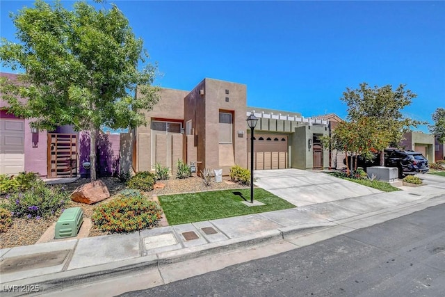 130 Twin Towers Ave, Las Vegas, NV 89123 - view of front facade with concrete driveway, an attached garage, stucco siding, and fence