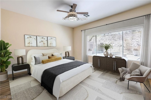35 Glade Water Dr, Henderson, NV 89052 - bedroom with multiple windows, wood finished floors, and baseboards