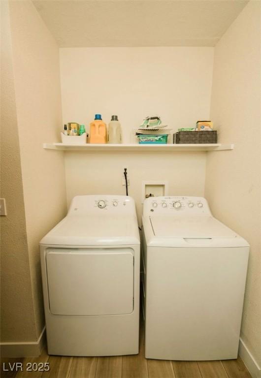 3789 Heritage Ave, Las Vegas, NV 89121 - clothes washing area featuring washer and dryer, wood finished floors, and baseboards