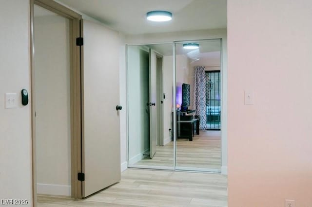 3789 Heritage Ave, Las Vegas, NV 89121 - hallway with light wood-style floors and baseboards