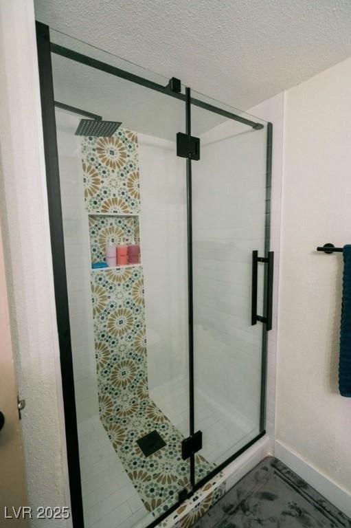 3789 Heritage Ave, Las Vegas, NV 89121 - full bath with a stall shower, baseboards, and a textured ceiling