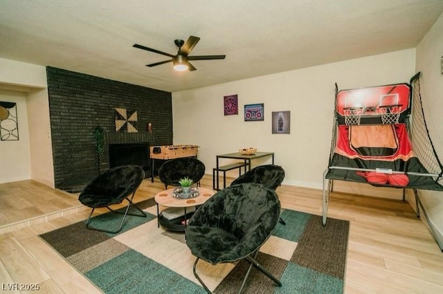 3789 Heritage Ave, Las Vegas, NV 89121 - living area featuring a fireplace, wood finished floors, and ceiling fan