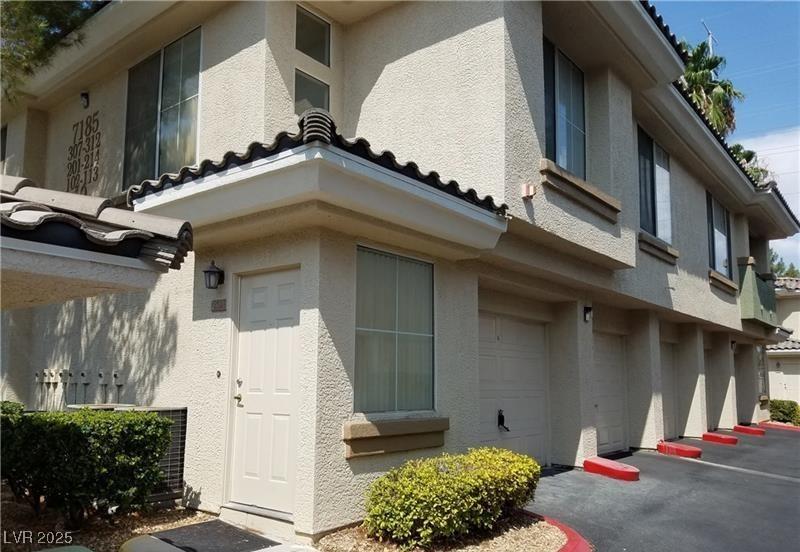 view of home's exterior with an attached garage and stucco siding