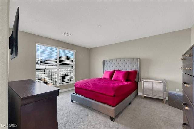 carpeted bedroom with baseboards and visible vents