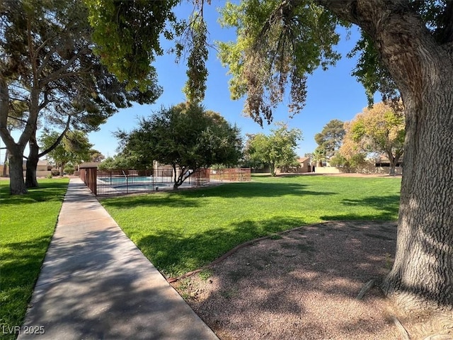 view of community featuring a yard and a pool