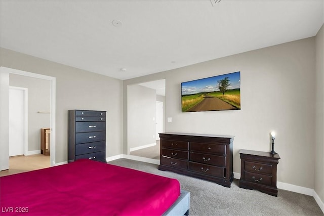 carpeted bedroom featuring baseboards