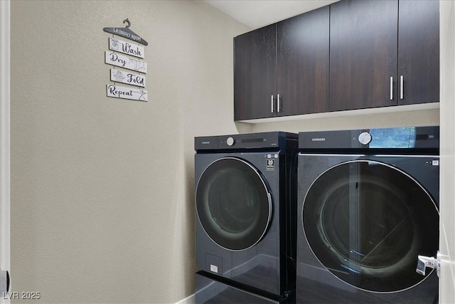 laundry area featuring cabinet space and washing machine and dryer