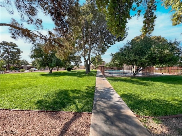 surrounding community featuring a lawn and fence