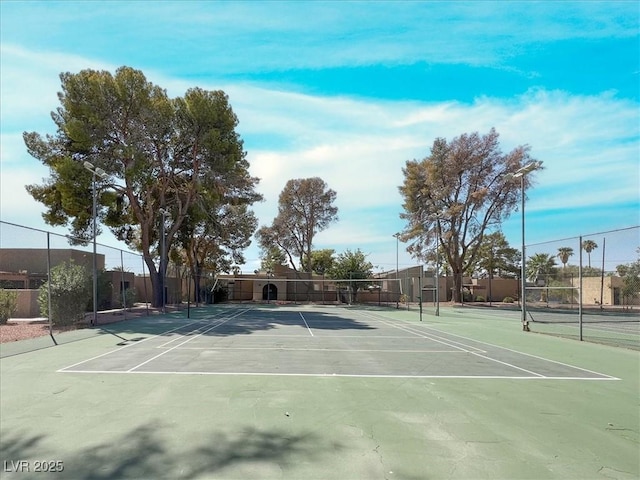 view of tennis court featuring fence
