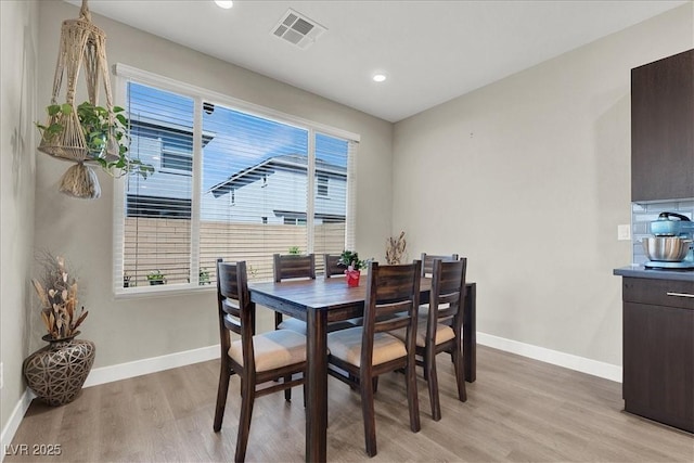 dining room with light wood-style floors, baseboards, recessed lighting, and visible vents