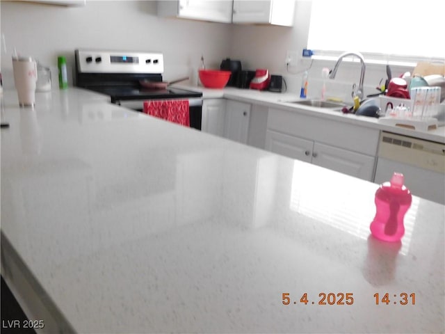 kitchen featuring white dishwasher, stainless steel electric range, a sink, light countertops, and white cabinetry